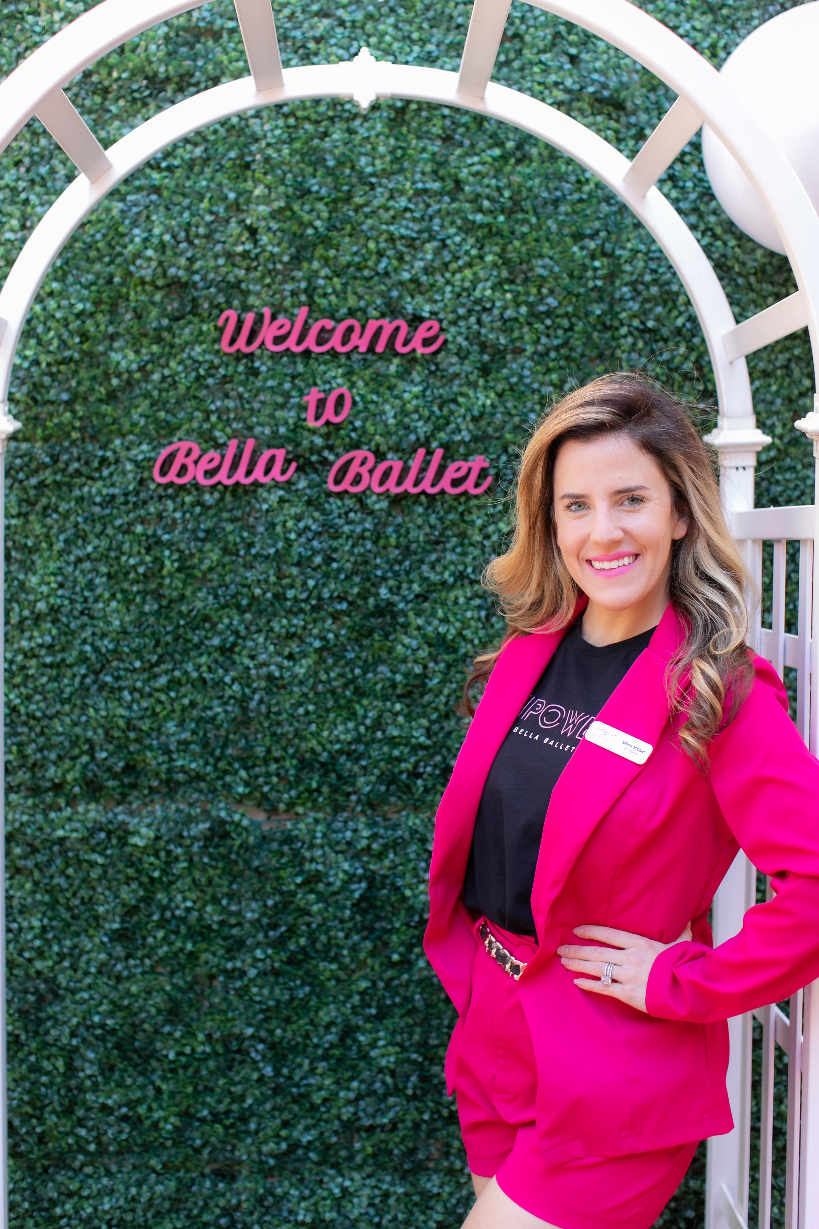 Bella Ballet founder at Welcome to Bella Ballet sign